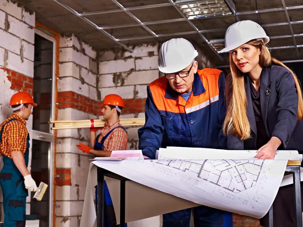 Business woman in builder helmet